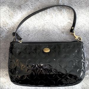 Black patent leather Coach medium-sized wristlet.